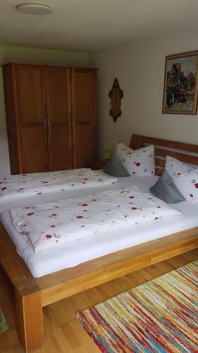two beds with pillows and pillows in a room at Casa Patrizia in Schwangau