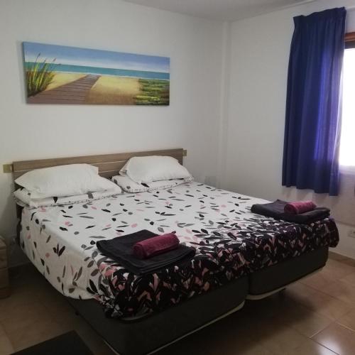 a small bedroom with a bed with at Arinaga Beach & Pool Apartment in Arinaga
