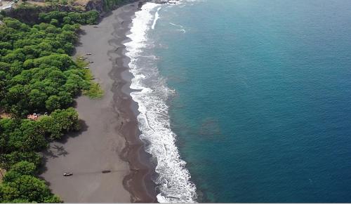 an aerial view of a beach next to the water at Dunas De Areia Preta in Ribeira da Prata