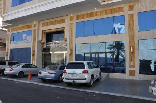 a white car parked in front of a building at Abdul Hafez Al Humaidan Hotel in Makkah