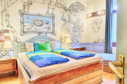 two beds in a room with drawings on the wall at Lavender Circus Hostel, Doubles & Ensuites in Budapest