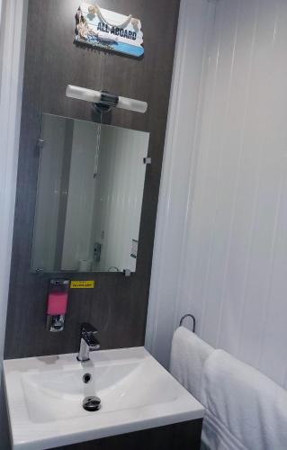 a bathroom with a white sink and a mirror at Kings Boutique Hotel in Blackpool
