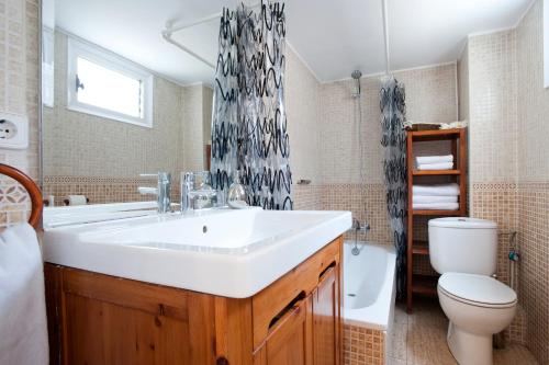 a bathroom with a white sink and a toilet at Rainbow in Barcelona