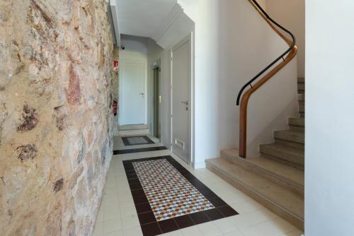 a hallway with stairs and a brick wall at Zamora Suites Central in Zamora