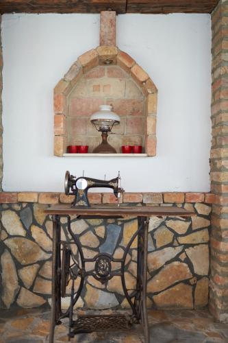 a stone wall with a table with a mirror at Gästezimmer Victoria in Linsberg