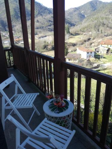 einen Balkon mit 2 Stühlen und einem Tisch mit Weingläsern in der Unterkunft Fiordiluna near 5 terre in Beverino