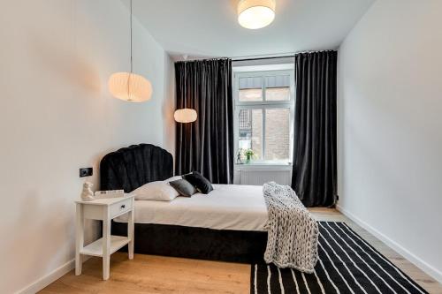 a bedroom with a bed and a window at Jan III Sobieski - Luksusowy apartament L z darmowym prywatnym parkingiem in Gliwice