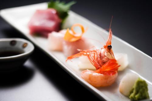 a plate of food with a shrimp and other foods at Motoyu Ishiya in Kanazawa