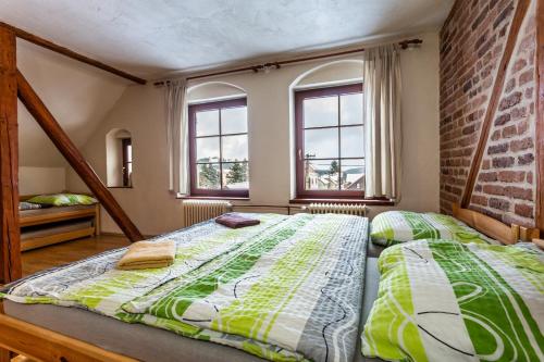 two beds in a room with two windows at Chata Plešivka in Abertamy