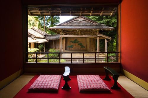 two chairs in a room with a window at Motoyu Ishiya in Kanazawa