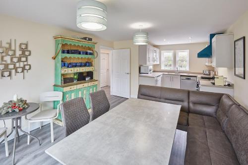 a kitchen and living room with a table and chairs at Host & Stay - Carlewell Cottage in Middlesmoor