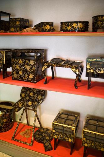 a set of shelves with chairs and baskets on them at Motoyu Ishiya in Kanazawa