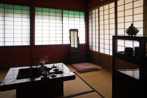 a room with a stove in a room with windows at Motoyu Ishiya in Kanazawa