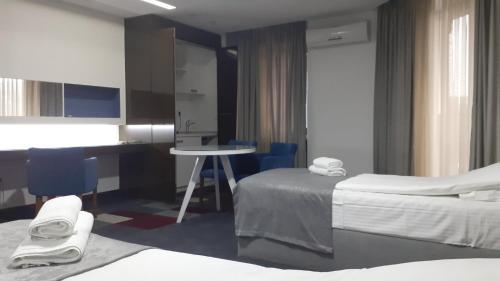 a hotel room with two beds and a desk at Hotel Boutique Bristol in Sarajevo