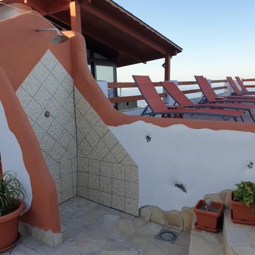 a slide on the side of a house with chairs at Casa in The Clouds in Genovés