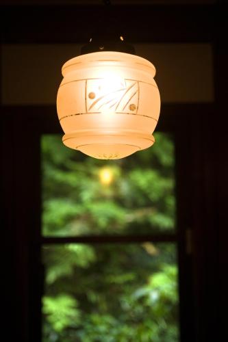 a light hanging in front of a window at Motoyu Ishiya in Kanazawa