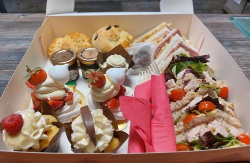 a box filled with different types of pastries and desserts at Kings Boutique Hotel in Blackpool