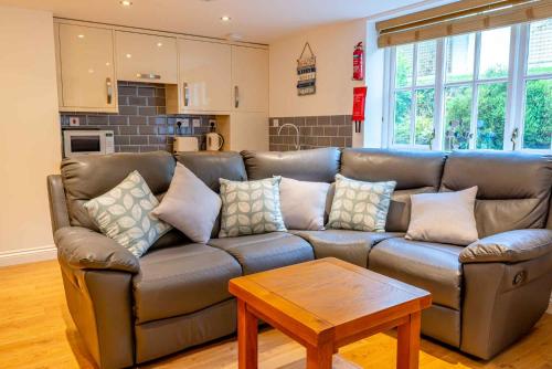 a living room with a couch and a table at Falmouth Bay Holiday Apartments in Falmouth
