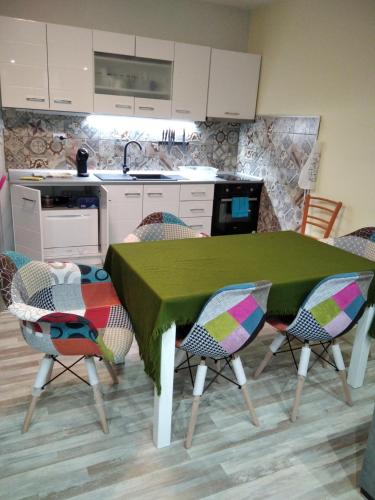 a kitchen with a table and chairs in a kitchen at ТИХОТО МЯСТО in Burgas City