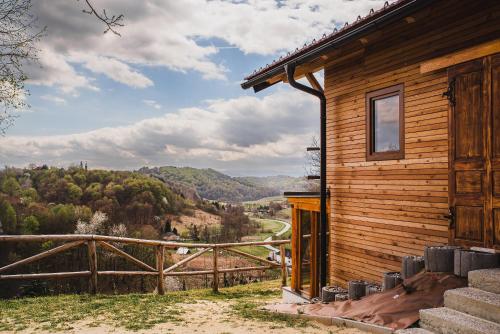a wooden house with a view of a valley at Holiday Home Liberg with Hot tub and Sauna in Brežice