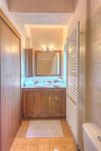 a bathroom with a sink and a tub and a mirror at Gerania Villa in Písia