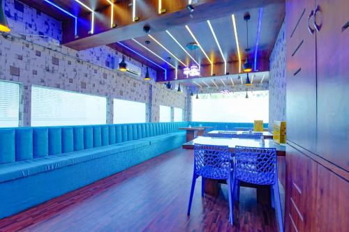a dining room with a table and two chairs at FabHotel New kolkata Residency Inn - Nr Axis Mall in Kolkata