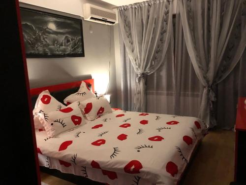 a bedroom with a bed with red hearts on it at Sunshine villa Dzhigurovo in Sandanski