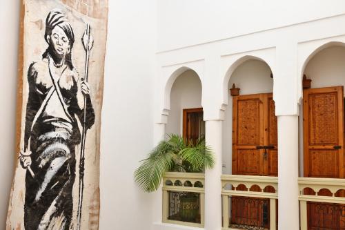 a wall with a painting of a lion on it at Riad Lamzia in Marrakesh