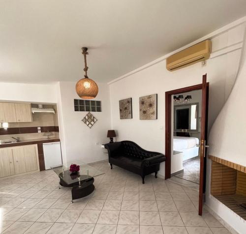 a living room with a couch and a fireplace at Danae Villa in Fira