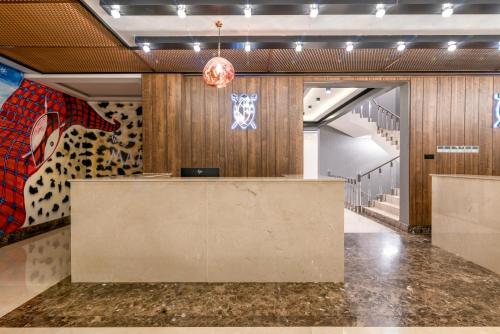 a lobby with a reception desk in a building at MAA Hotel and Suites - Hurlingham, Nairobi in Nairobi
