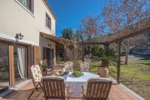 a patio with a table and chairs on a patio at Gerania Villa in Písia