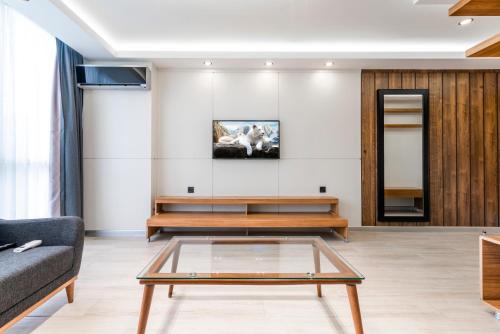 a living room with a glass coffee table at MAA Hotel and Suites - Hurlingham, Nairobi in Nairobi