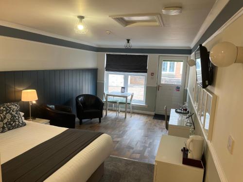 a hotel room with a bed and a living room at Witchwood House in Oban