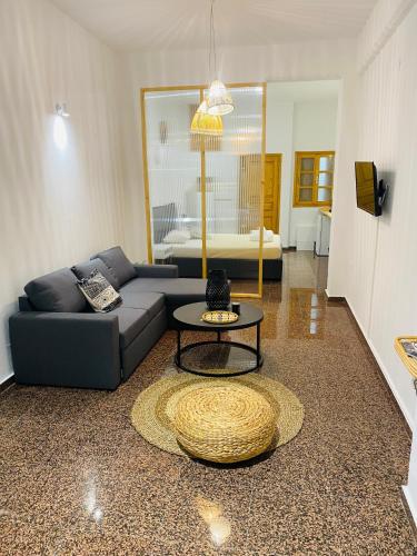 a living room with a couch and a table at Homdwell Fine Living 1 in Ermoupoli