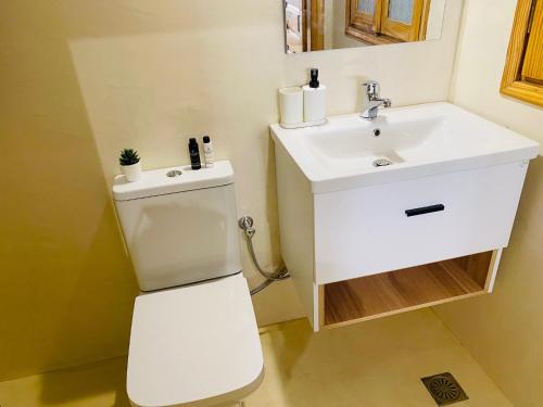 a bathroom with a toilet and a sink at Homdwell Fine Living 1 in Ermoupoli