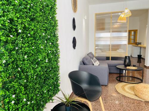 a living room with a couch and a green wall at Homdwell Fine Living 1 in Ermoupoli
