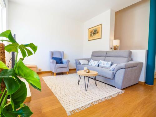 a living room with a couch and two chairs at Elite Bonaire Penthouse by Hello Homes Sitges in Sitges