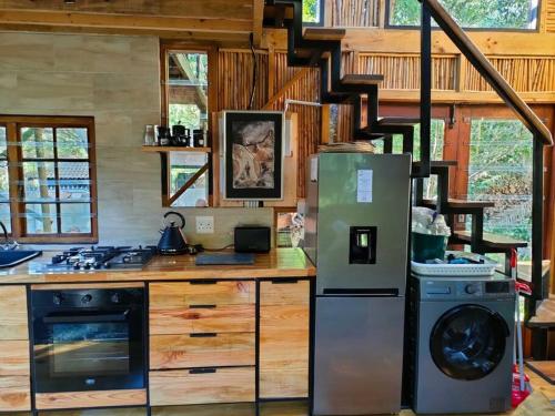 a kitchen with a stove and a refrigerator at ZenCapeTown Forest Retreat in Cape Town