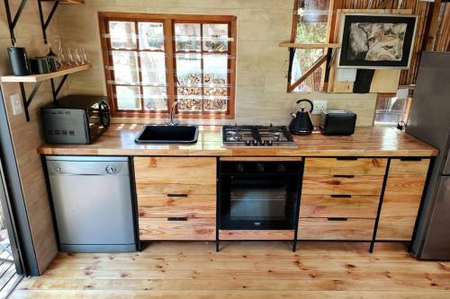 a kitchen with wooden counters and a stove top oven at ZenCapeTown Forest Retreat in Cape Town