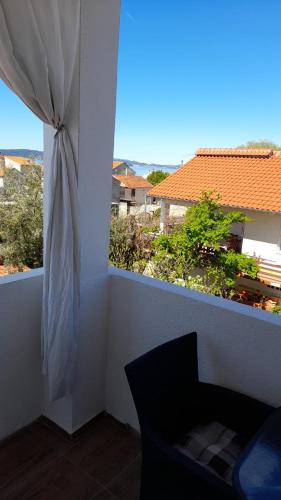 a balcony with a window with a view of a building at Apartments Mira in Bibinje