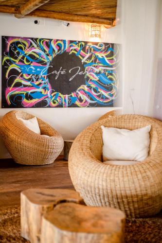 a room with a chair and a painting on the wall at Café Jeri Hotel - Adults Only in Jericoacoara