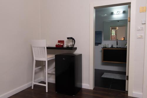 a kitchen with a table and a chair in a room at Prestige Room in Prestige location Bahai's Garden in Haifa