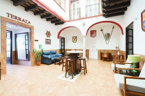 a living room with a table and chairs at Hotel Carlos V Jerez by Vivere Stays in Jerez de la Frontera