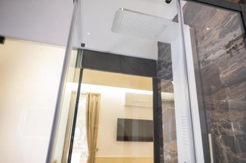 a glass window in a room with a stone wall at Luxury B&B La Riserva Dannunziana in Pescara