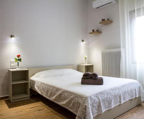 a bedroom with a bed with two towels on it at Paradise of Meteora A in Kastrákion