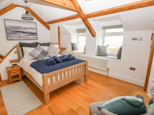 a bedroom with a bed and a couch at 1 Salt Cottage in Swansea