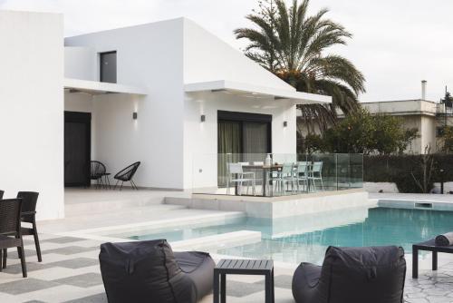 a villa with a swimming pool and a house at Villa De Reve in Laganas