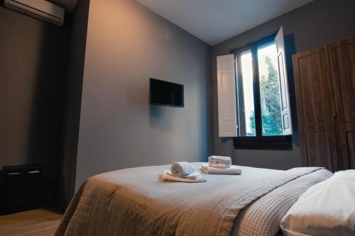 a bedroom with two dolls laying on a bed at Palazzo Oliveto in Florence
