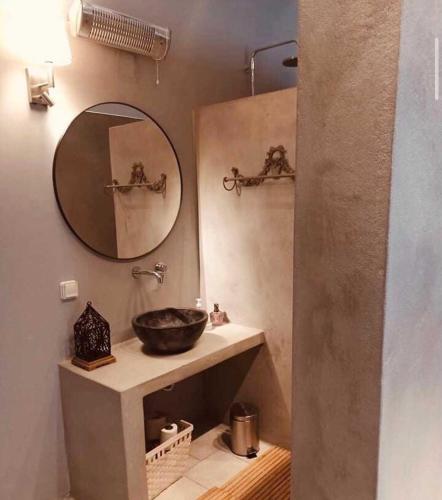 a bathroom with a sink and a mirror at Ambrosia in Tinos