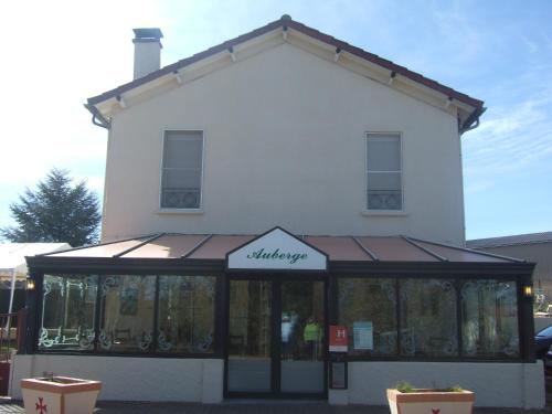 a large white building with a sign on it at Auberge le Cévenol in La Cavalerie